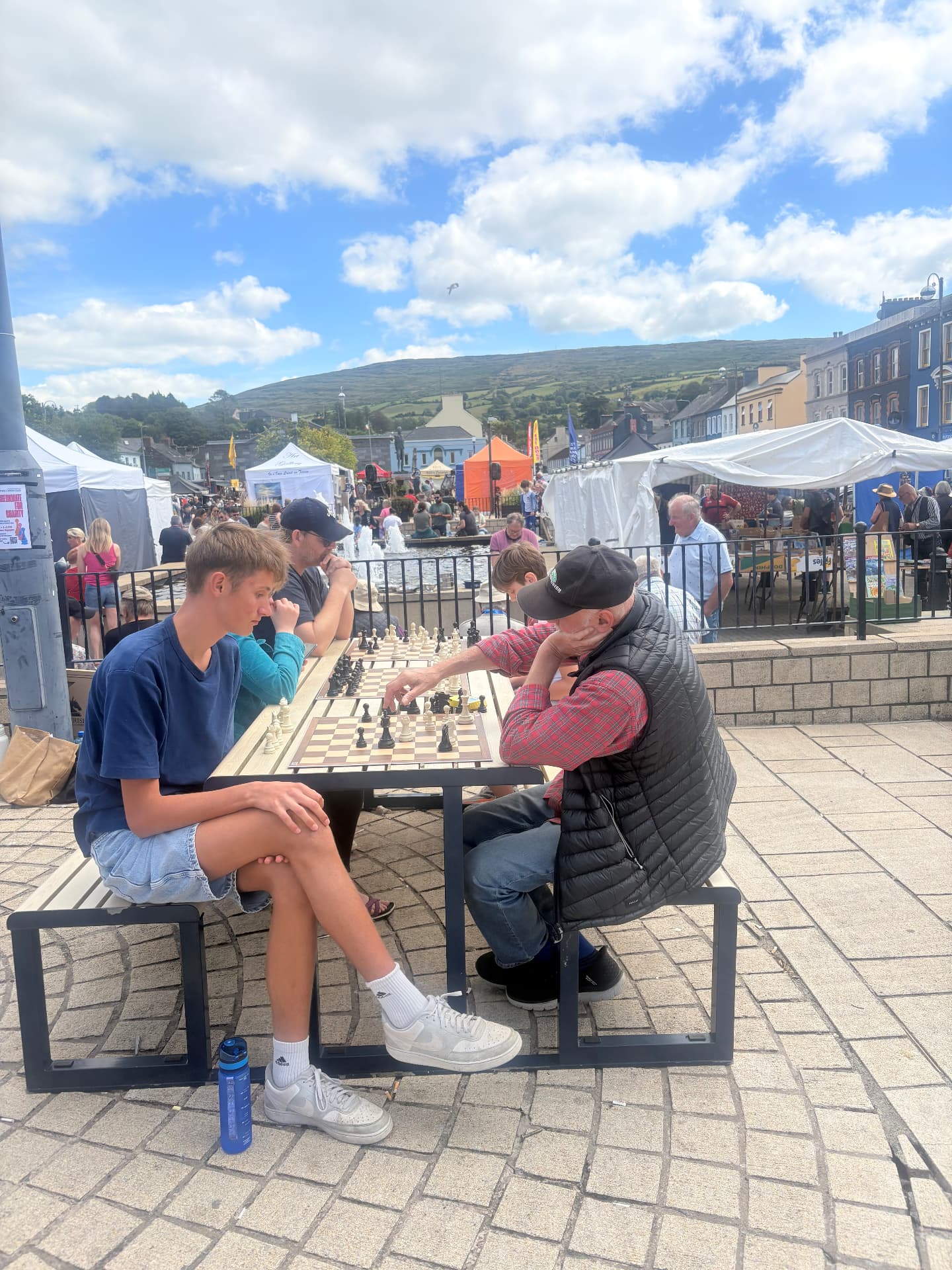 Players of all ages facing club members across the boards at Checkmate for Charity in Bantry Town Square