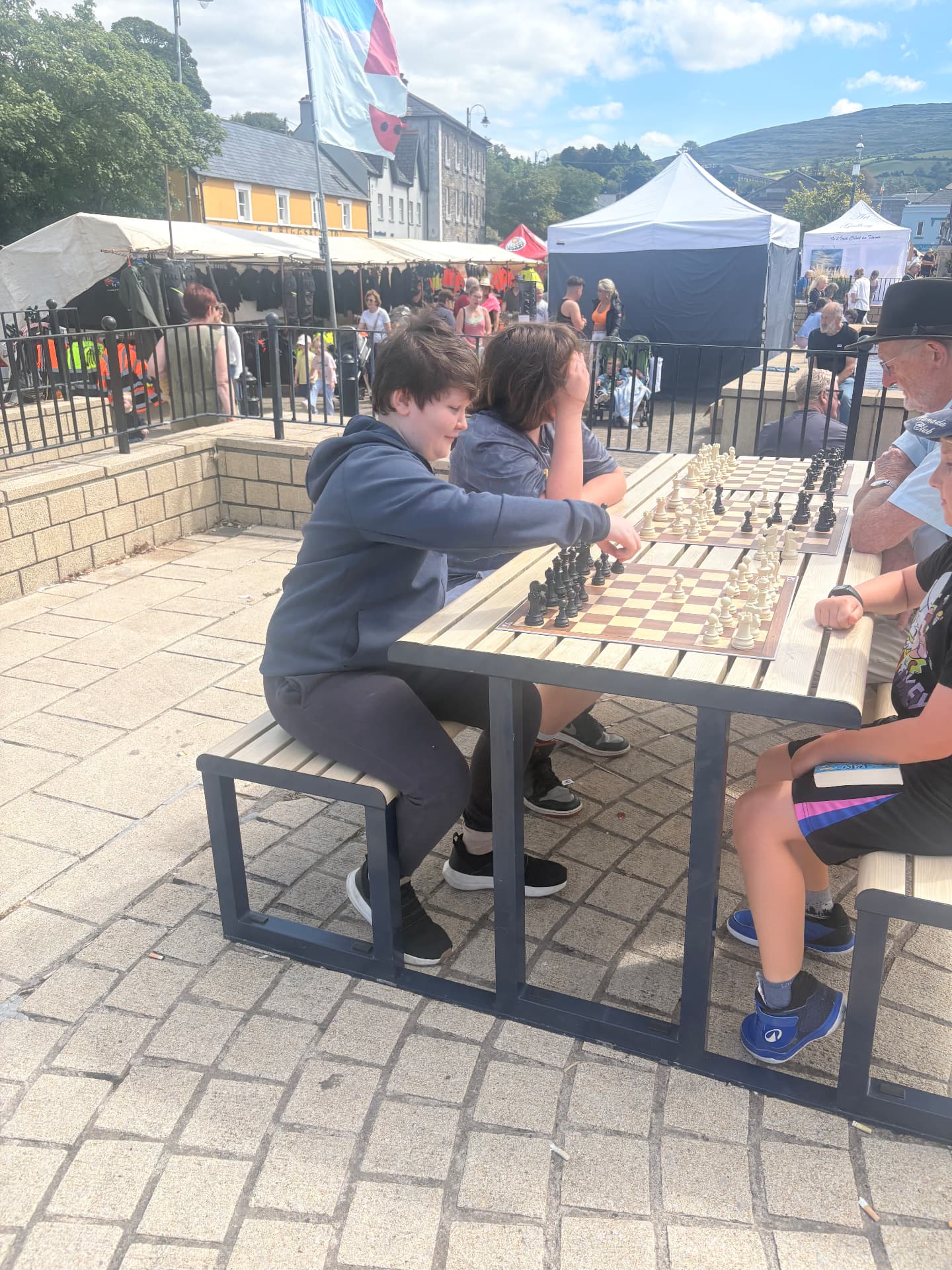 Junior players thinking hard over their boards at Checkmate for Charity in Bantry Town Square