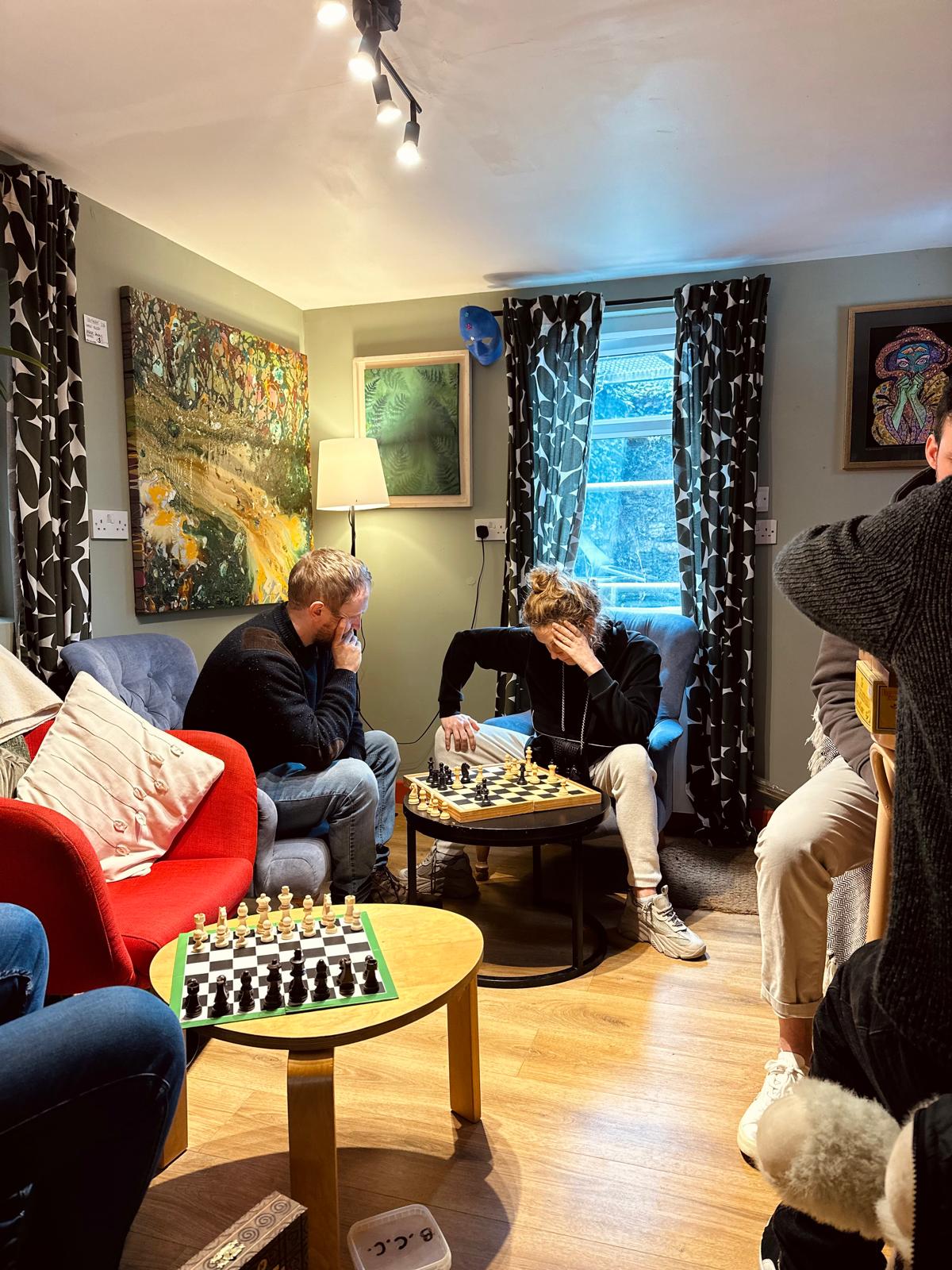 Members playing in a warm living-room setting